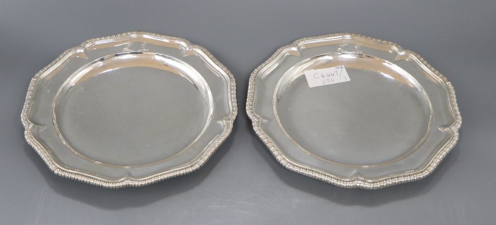 A pair of George IV silver shaped circular dinner plates, with gadrooned borders,